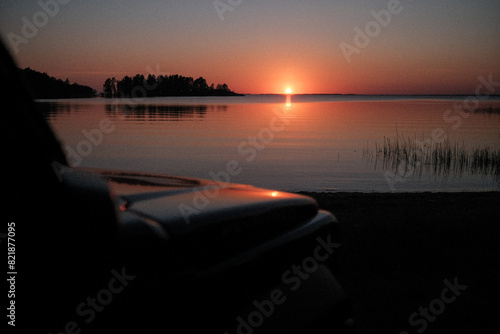 Tranquil Scandinavian Summer Sunset Over Serene Lake with Campervan photo