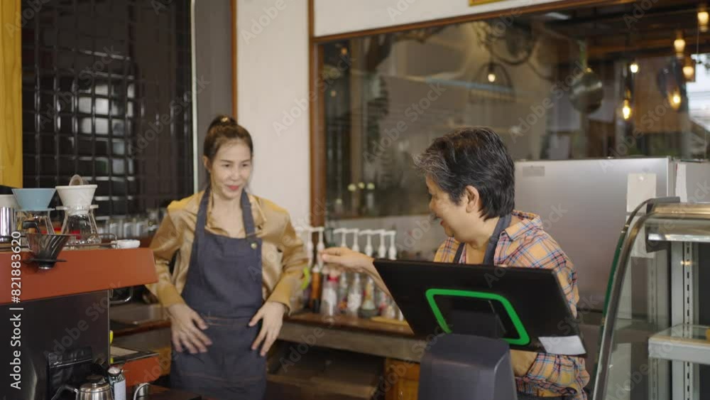 Senior, elderly, retired, women and daughters are happy to do well in beverage and food sales in her coffee shop. Small business, Business owner. Senior, elderly, retired, women and daughters are happy to do well in beverage and food sales in her coffee shop. Small business, Business owner.
