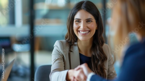 Fototapeta Naklejka Na Ścianę i Meble -  Happy business woman handshaking at office meeting. Smiling female hr hiring recruit at job interview, bank or insurance agent, lawyer making deal with client at work