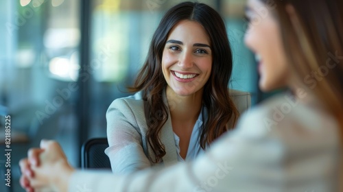 Fototapeta Naklejka Na Ścianę i Meble -  Happy business woman handshaking at office meeting. Smiling female hr hiring recruit at job interview, bank or insurance agent, lawyer making deal with client at work