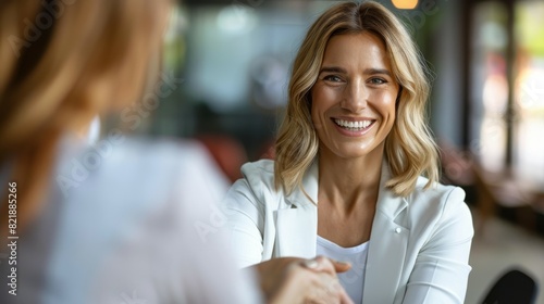 Fototapeta Naklejka Na Ścianę i Meble -  Happy business woman handshaking at office meeting. Smiling female hr hiring recruit at job interview, bank or insurance agent, lawyer making deal with client at work