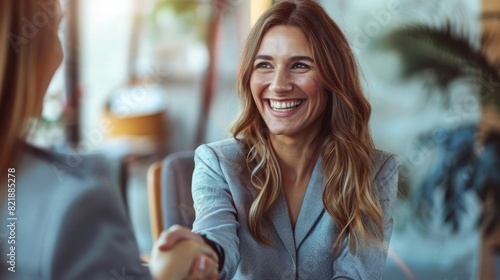 Fototapeta Naklejka Na Ścianę i Meble -  Happy business woman handshaking at office meeting. Smiling female hr hiring recruit at job interview, bank or insurance agent, lawyer making deal with client at work