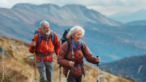 Portrait of active elderly couple hiking together in park. Senior tourists walking with trekking poles. Bright smile and happy. Copy space.