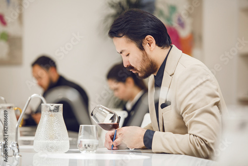 Canvas Print Sommelier Evaluating Red Wine at Winemaking Course.