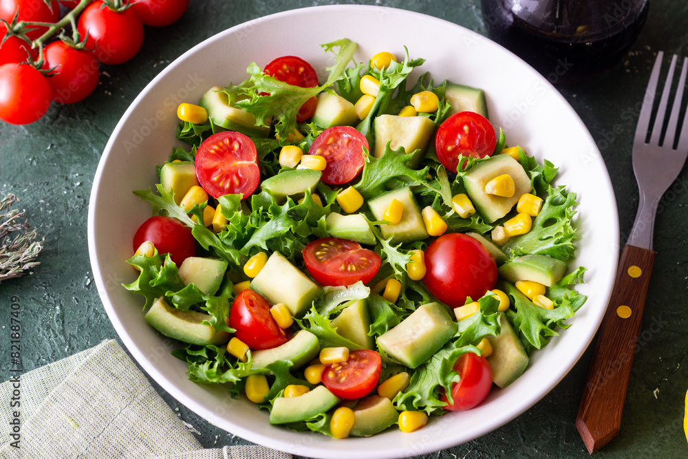 Salad with avocado, tomatoes and corn. Healthy eating. Vegetarian food. Salad with avocado, tomatoes and corn. Healthy eating. Vegetarian food.