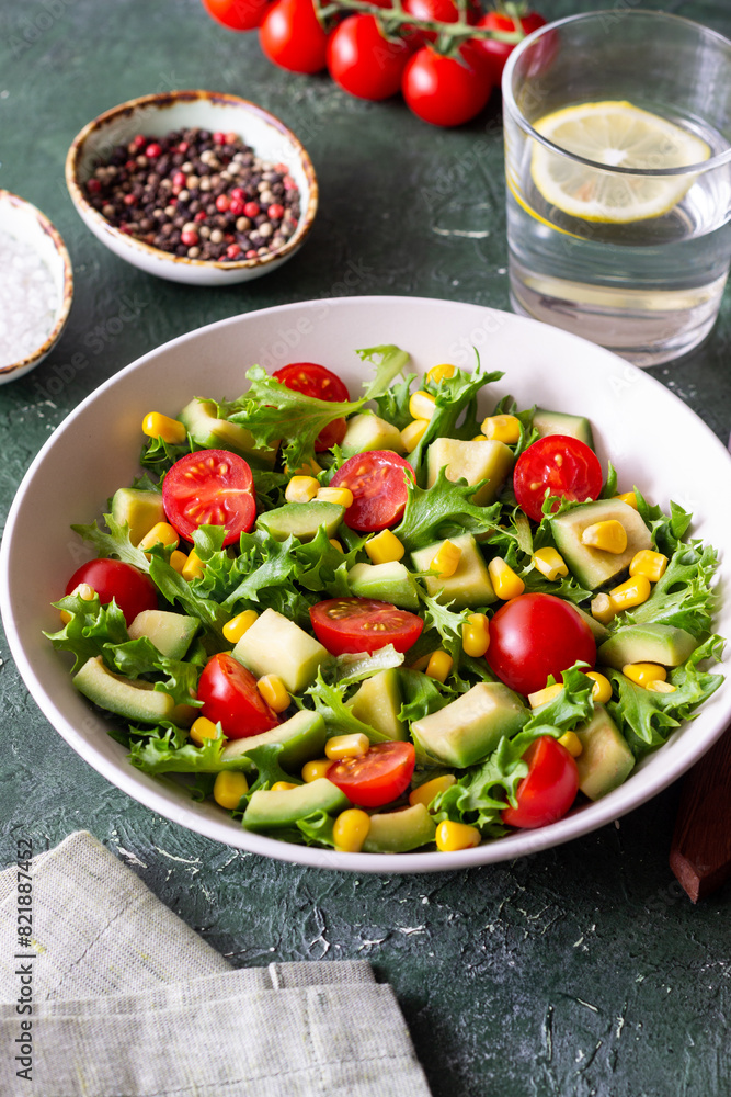 Salad with avocado, tomatoes and corn. Healthy eating. Vegetarian food. Salad with avocado, tomatoes and corn. Healthy eating. Vegetarian food.