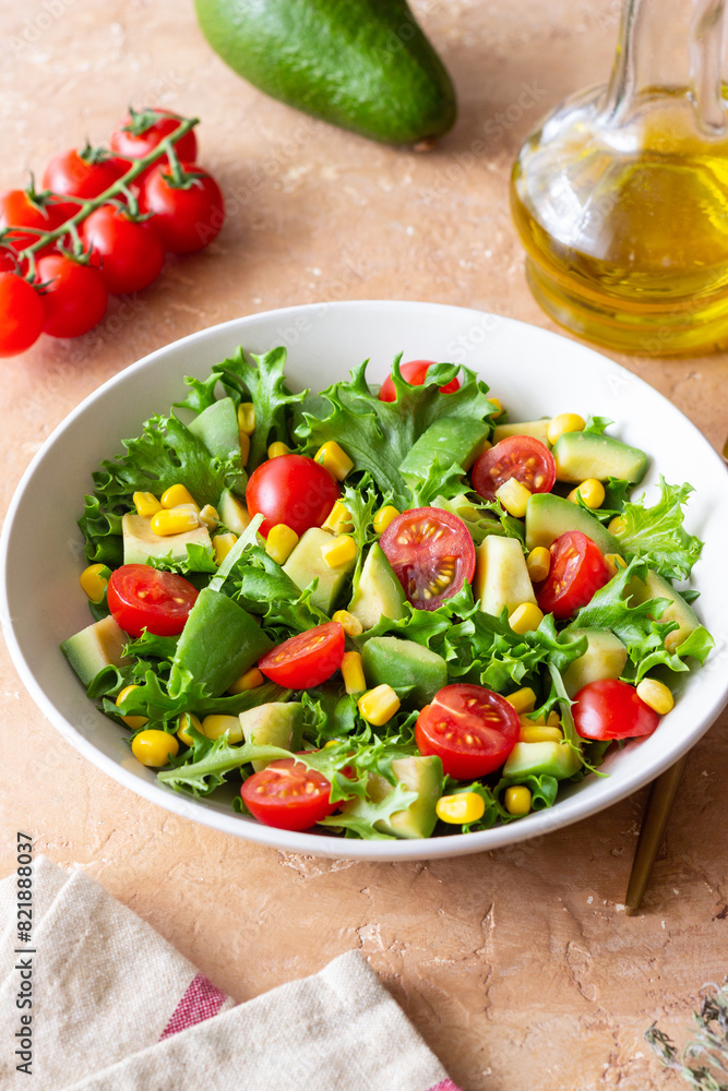 Salad with avocado, tomatoes and corn. Healthy eating. Vegetarian food. Salad with avocado, tomatoes and corn. Healthy eating. Vegetarian food.