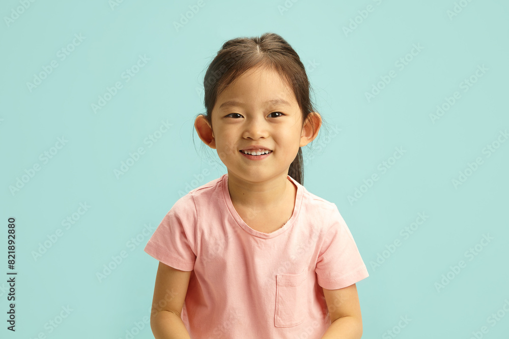 Smiling Young Asian Child Girl on Blue Background Smiling Young Asian Child Girl on Blue Background