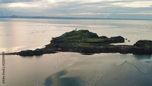 Aerial view of Fidra island with picturesque lighthouse on rocky coastline, East Lothian, Scotland. photo