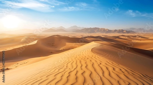 Serene desert dunes stretching into the distance under a clear blue sky, bathed in warm sunlight. © Khan