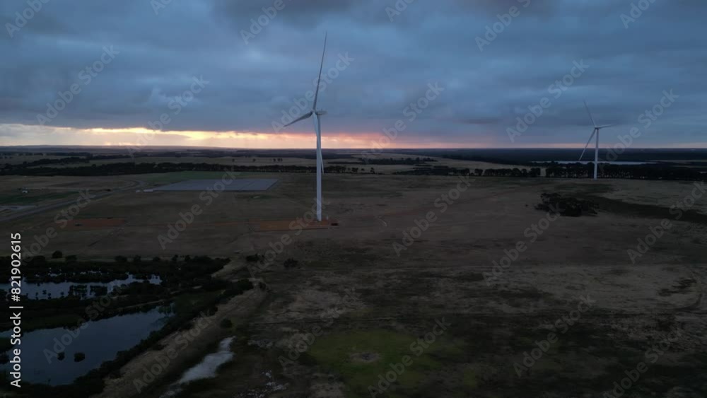Wind turbines spinning at dusk, Esperance area in Western Australia. Aerial drone view Wind turbines spinning at dusk, Esperance area in Western Australia. Aerial drone view