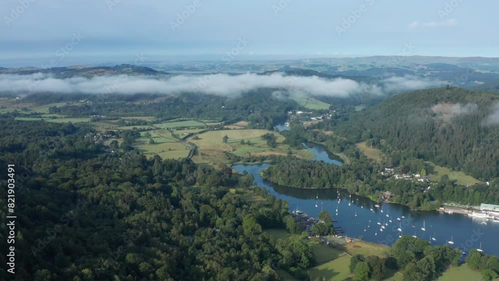 Aerial view of Lake Windermere surrounded by forest and hills, Ulverston, England. Aerial view of Lake Windermere surrounded by forest and hills, Ulverston, England.