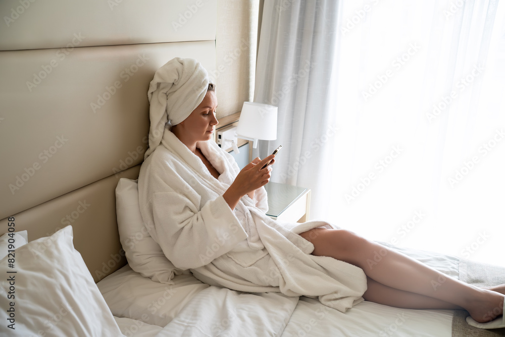 Woman in a bathrobe relaxes after a spa in a hotel. Woman in a bathrobe relaxes after a spa in a hotel.