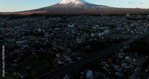 Aerial View Of Fujiyoshida City At Sunrise In Yamanashi Prefecture, Japan. Mount Fuji Revealed In Background. tilt-up shot photo