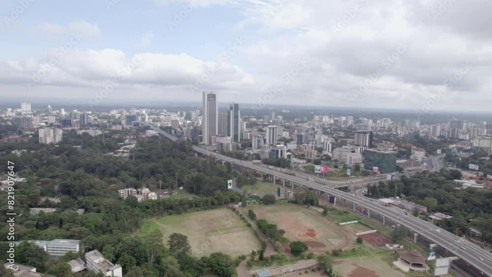 Aerial view of expressway, skyscrapers, and trees in Nairobi City, Kenya. Aerial view of expressway, skyscrapers, and trees in Nairobi City, Kenya.