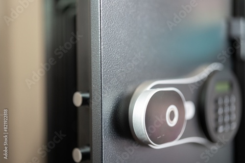 A safety box with heavy-thick steel door is opening , close-up and selective focus. Financial security robbery scene concept.