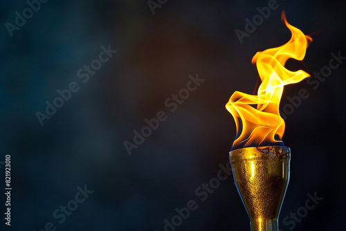 torch with Olympic flame on a dark background, copyspace 