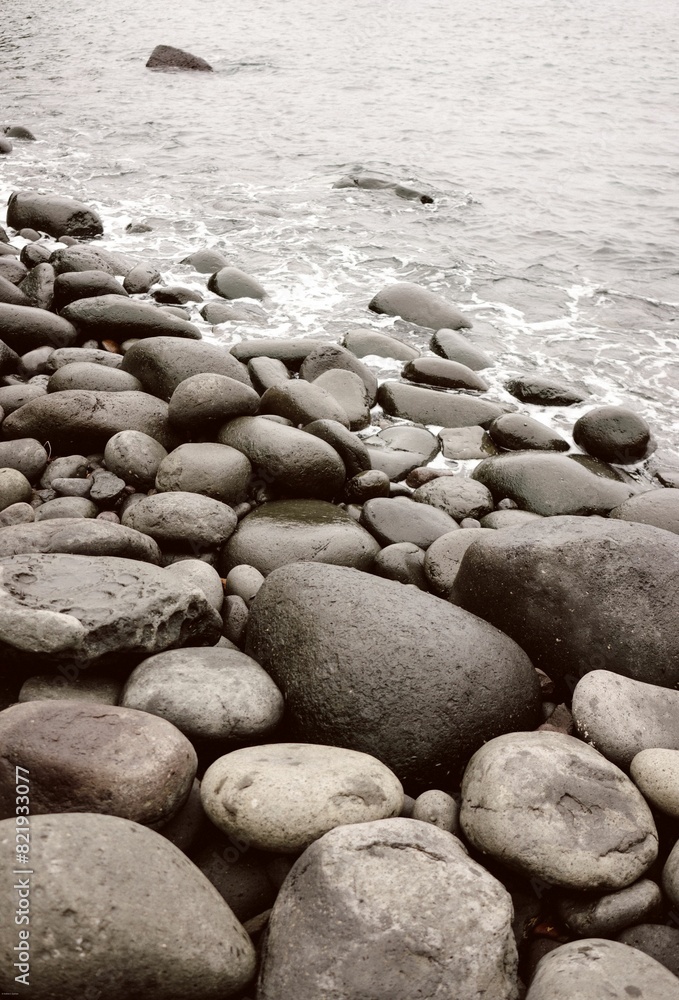 Expansive stretch of rocky beach washed by the lapping waves of the sea Expansive stretch of rocky beach washed by the lapping waves of the sea