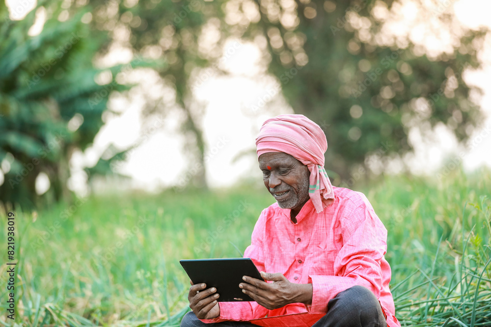 Fototapeta premium Indian farm worker holding tablet