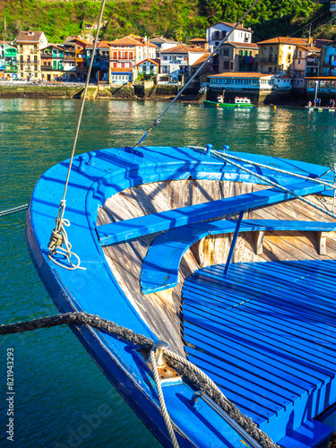 Fishing village of Pasajes de San Juan with a fishing boat in the foreground. Gipuzkoa, Basque country, Spain.