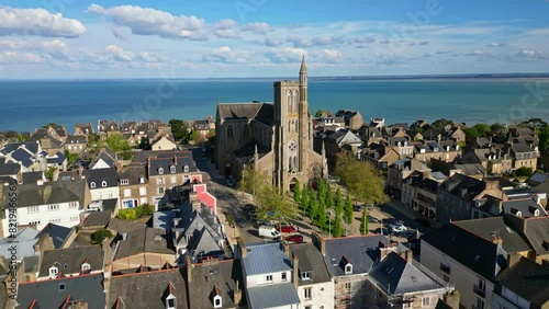 Saint-Meen church with sea in background, Cancale, Brittany in France. Aerial drone forward photo