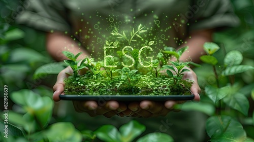 Businessman holds tablet with social governance message ESG and environmental icon holograms for climate change action. and the concept of sustainable living photo