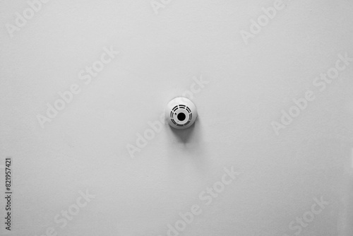 Minimalist Smoke Detector on White Wall for Home Safety and Security Design