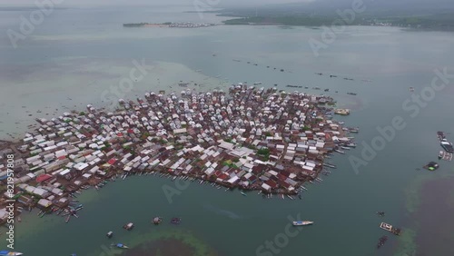 Aerial view of crowded fishing village at sunrise, Bungin Island, Indonesia. photo