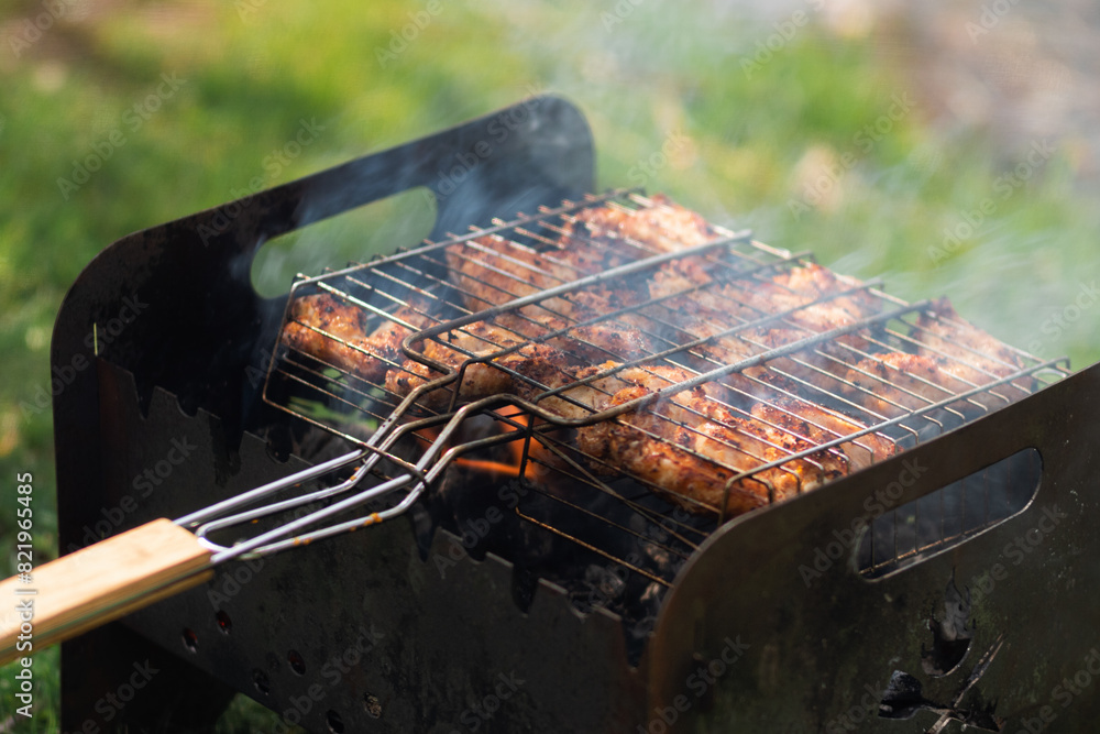 Chicken wings grilled on the grill in a BBQ grate Chicken wings grilled on the grill in a BBQ grate