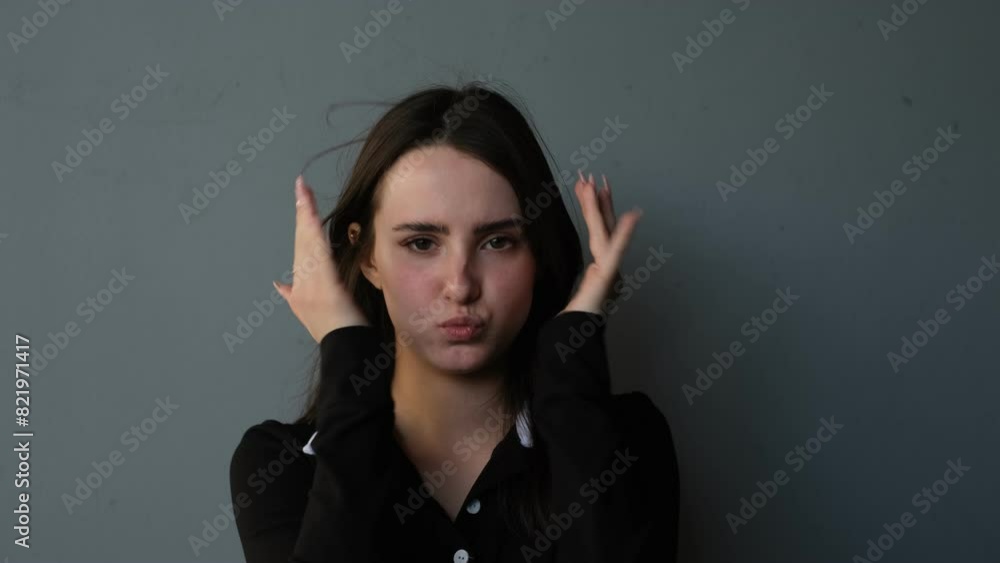 A young woman plays with a child, covers her face with her hands and grimaces A young woman plays with a child, covers her face with her hands and grimaces
