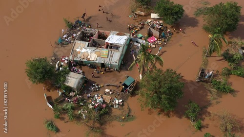 Aerial footage over poor African people with damaged houses and trees in the flood in Mozambique photo