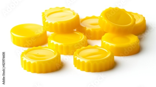 Bottle caps made of yellow plastic isolated on white photo