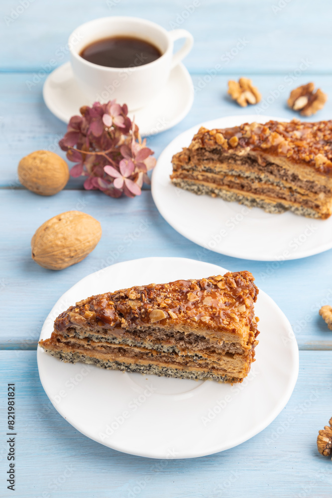 Walnut and hazelnut cake with caramel on blue wooden. side view, copy space. Walnut and hazelnut cake with caramel on blue wooden. side view, copy space.