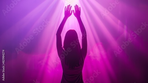 An image of a woman raising her hands in worship against a purple and pink Christian-themed background. Concept Worship, Christian Theme, Raising Hands, Purple Background, Pink Background.