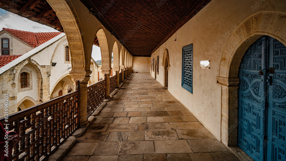 Fototapeta premium a narrow walkway with arches, windows and a gate that leads to an ancient building
