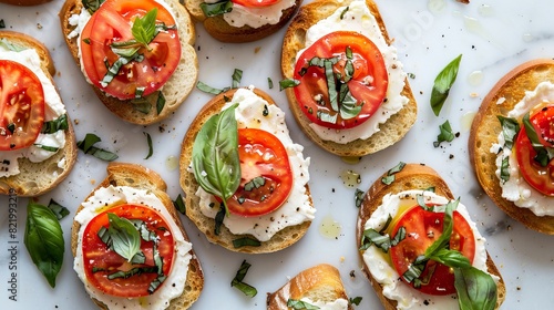 Crispy toasted bread slices topped with ripe tomatoes, creamy cheese, a drizzle of olive oil, and fragrant basil. A classic Italian appetizer on a white marble background.