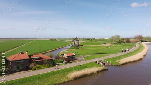 Aerial view of countryside with windmill, cycling, and fields, Schermerhorn, North Holland, Netherlands. photo