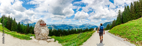 Panoramic Landscape Scenery. Mountain Jenner, Route Mitterkaseralm. Man Hiking in the National park Berchtesgadener Land in Summer, Bavaria, Germany.