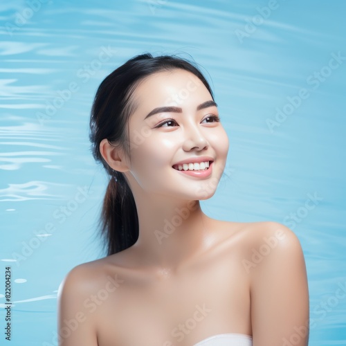 Aqua background Happy Asian Woman Portrait of young beautiful Smiling Woman good mood Isolated on Background Skin Care Face Beauty Product Banner with copyspace 