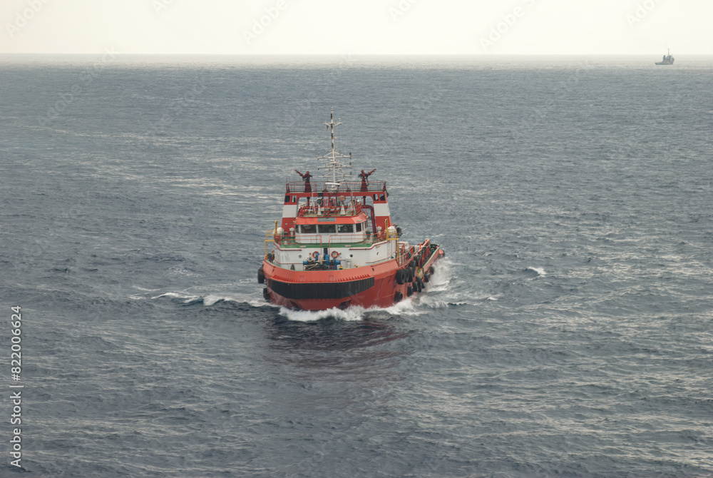 Supply boat transfer crew cargo to oil and gas offshore field front aerial view Supply boat transfer crew cargo to oil and gas offshore field front aerial view