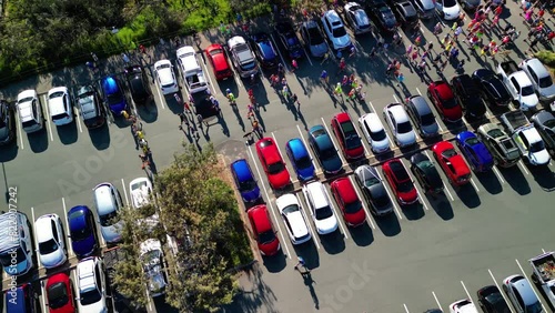 Aerial view of a crowd of people walking in the parking lot of Kawana parkrun in Buddina, Australia photo