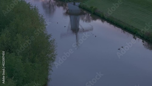 Aerial view of De Vlinder windmill, river Linge, and sunrise, Deil, Netherlands. photo