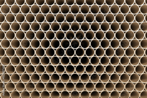 A large stack of new pipes lies on a construction site.