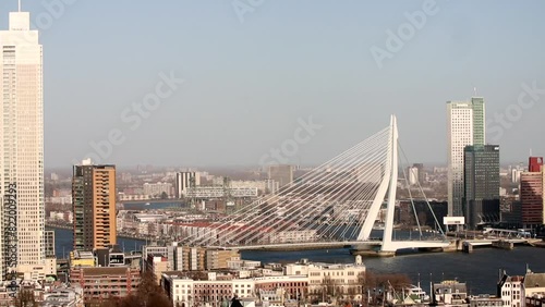 Static shot of Rotterdam skyline on a sunny day showing Erasmus Bridge and Meuse River in the view photo