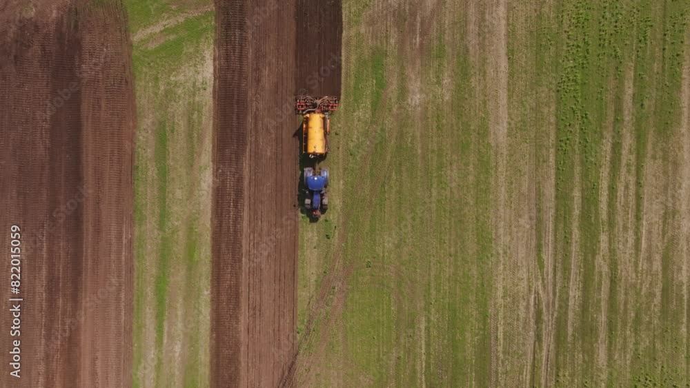 Aerial view of cultivated farmland with tractor in Bourtange, Groningen, Netherlands. Aerial view of cultivated farmland with tractor in Bourtange, Groningen, Netherlands.