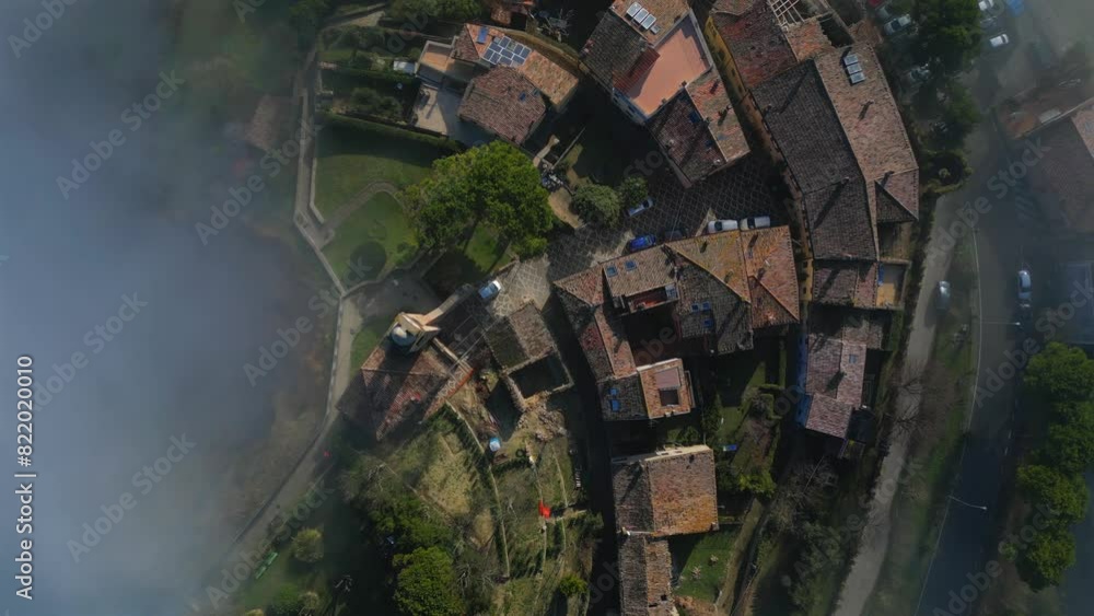 Drone of the medieval village of Fiorenzuola di Focara immersed in the fog in Italy Drone of the medieval village of Fiorenzuola di Focara immersed in the fog in Italy