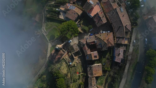 Drone of the medieval village of Fiorenzuola di Focara immersed in the fog in Italy photo