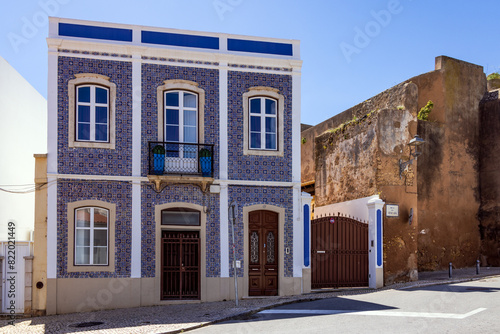 Blue and yellow tile facade refurbished neoclassical house on Rua da Atalaia street in the old town, , Lagos, Portugal photo