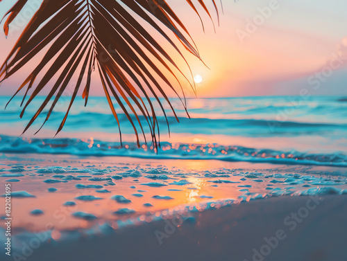 A serene tropical beach at sunset with palm leaves in the foreground and gentle waves lapping the shore in rosy twilight hues.