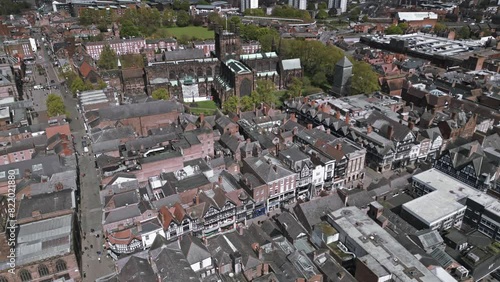 Aerial slow approach view of Chester cathedral and Eastgate Street, Cheshire, England photo